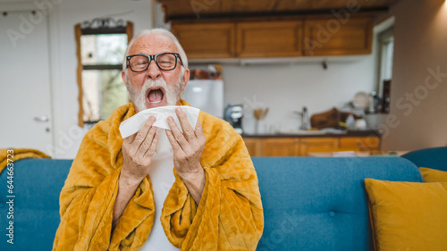 Obraz na plátne one senior man sit on sofa bed hold Paper tissue common cold sneezing
