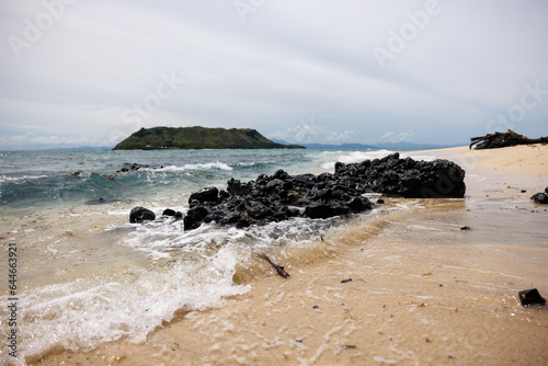 surf washing over rocks overlooking vomo island, fiji