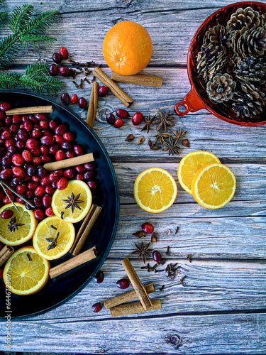 Flat lay ingredients on wooden surface to make home smell like Christmas with a homemade simmer stovetop Christmas potpourri.