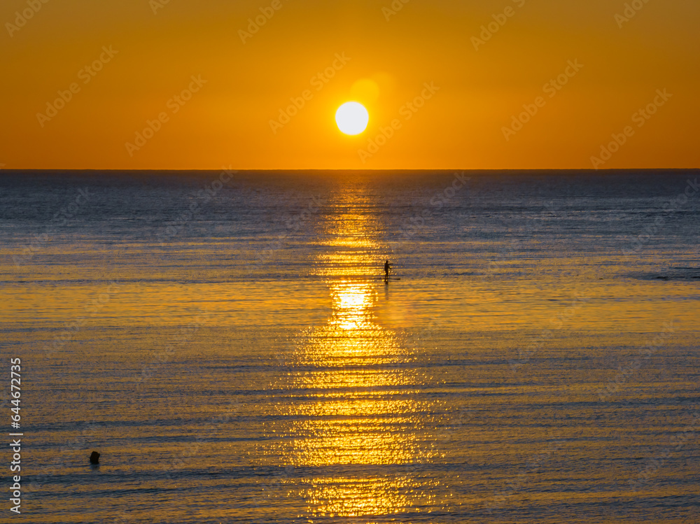 Sunrise with clear skies and calm seas