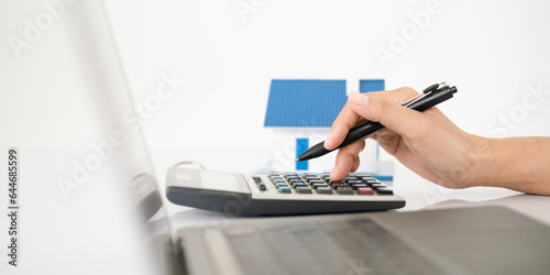 Hand of Business people calculating interest, taxes and profits to invest in real estate and home buying