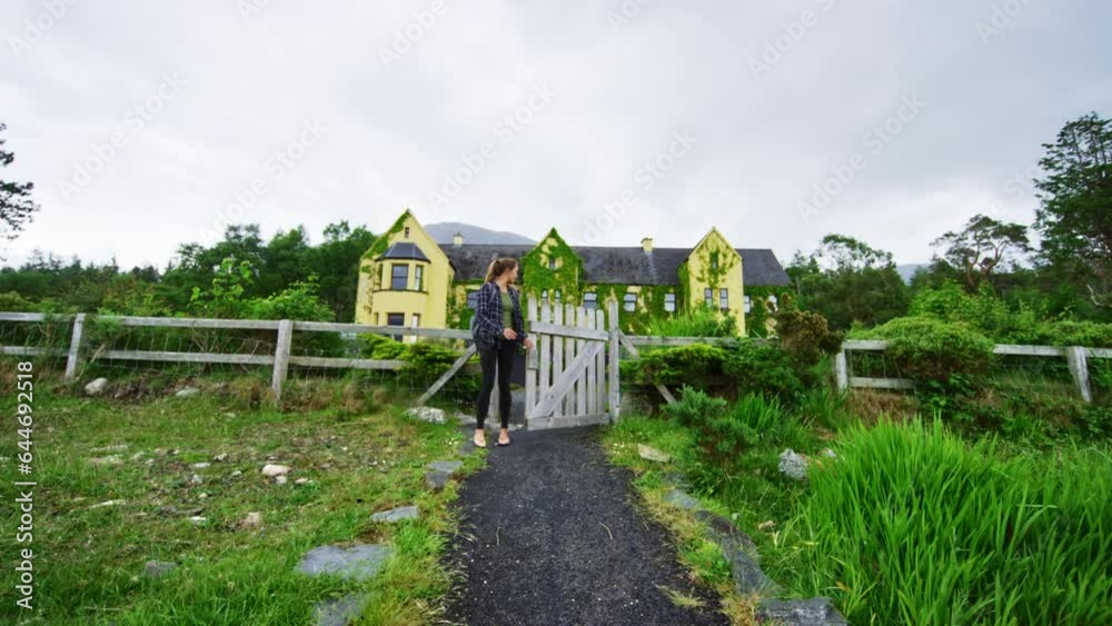 Woman Walking Through Gate To Trail In Ireland - Slow Motion Woman Walking Through Gate To Trail In Ireland - Slow Motion