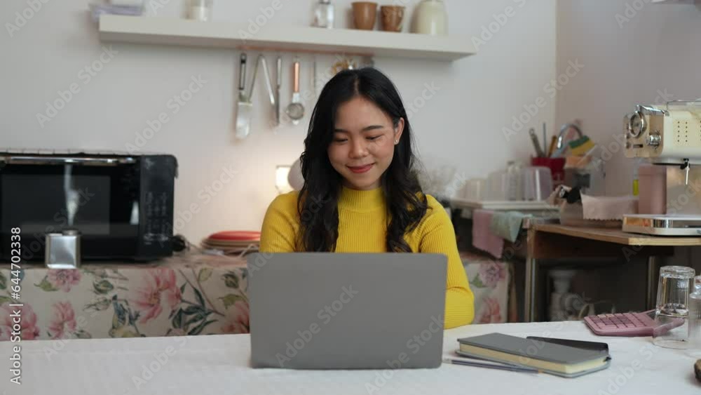 Young Asian businesswoman working using laptop computer on desk at freelance home. Relax. Stretching. Lifestyle of women studying and doing business online business and education concept Young Asian businesswoman working using laptop computer on desk at freelance home. Relax. Stretching. Lifestyle of women studying and doing business online business and education concept