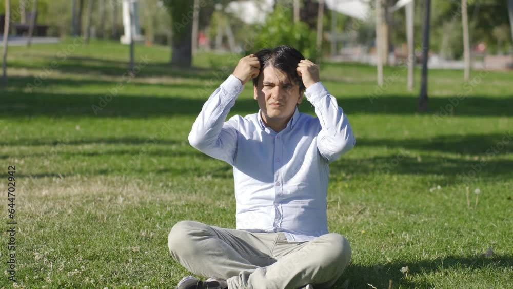 The young man who has hair loss problem is bored. The young man who has hair loss problem is bored.