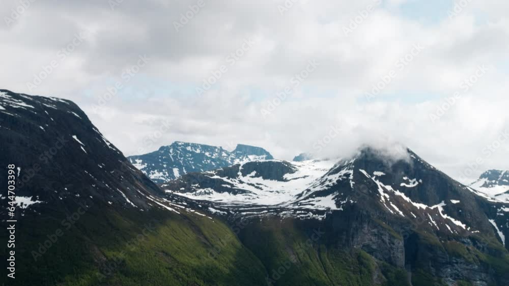 Norwegian fjord with dramatic clouds surrounding mountain peaks at the west coast of Norway at Sunnmøre, Liavarden Norwegian fjord with dramatic clouds surrounding mountain peaks at the west coast of Norway at Sunnmøre, Liavarden