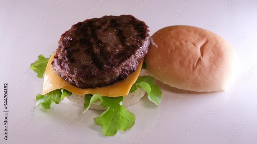 Professional cook folds a burger on board in restaurant kitchen close up. High quality 4k footage Professional cook folds a burger on board in restaurant kitchen close up. High quality 4k footage