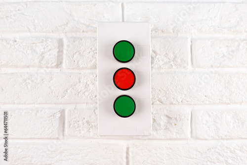 Push-button post - remote control of electrical installations, appliances, machines using three buttons on a white brick wall.fire alarm button, fire alarm, security, security mode, emergency