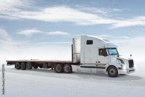 White long-distance bonnet truck with a semitrailer isolated on bright background with sky