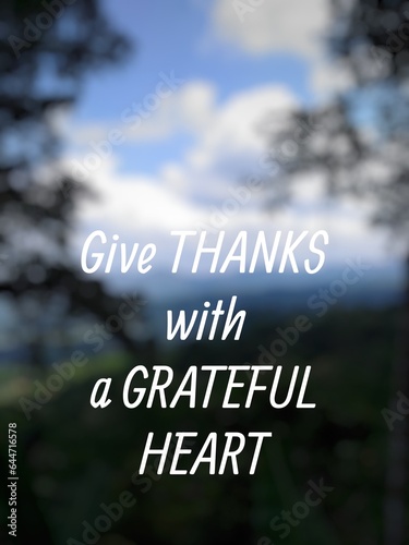 Motivational quote "Give thanks with a grateful heart" on nature background. Beautiful blue gradient of nature.