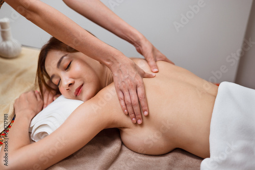 beautiful woman receiving massage in spa