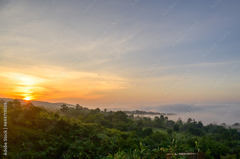 Morning sunrise with morning light on the mountain top with beautiful white mist sea of nature in Thailand.