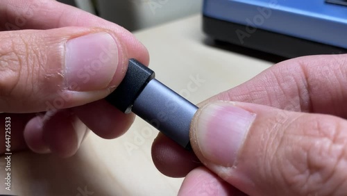 Close up view male hands fingers connect USB type C to USB adaptor and disconnect them 