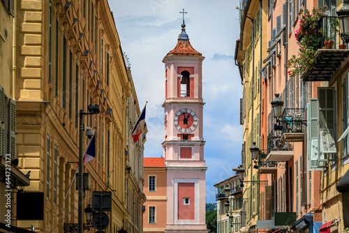 Fototapeta Naklejka Na Ścianę i Meble -  The Caserne Rusca clock tower with restaurants and shops in front of it in the streets of the Old Town, Vieille Ville of Nice France