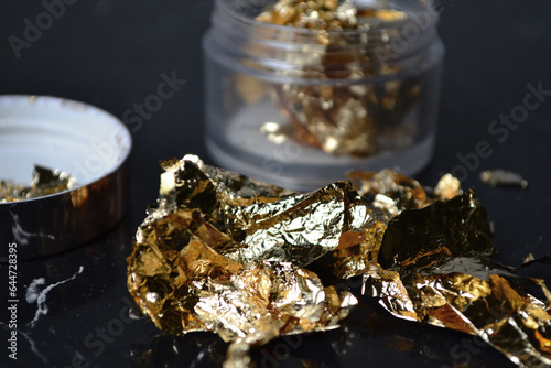 gold leaf in a jar on the table photo