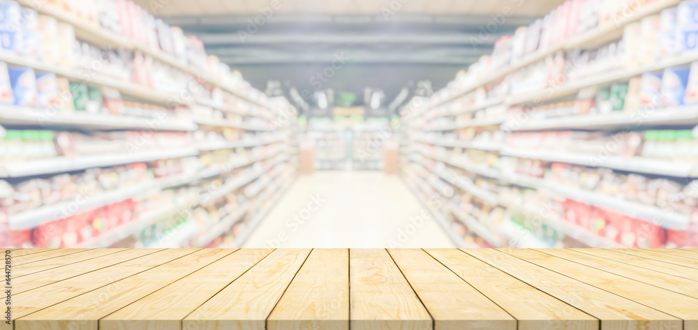 Wood table top with supermarket grocery store blurred background