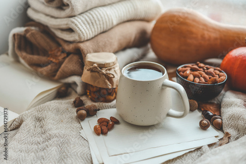 Cup of tea and almonds in autumn decor, good morning concept