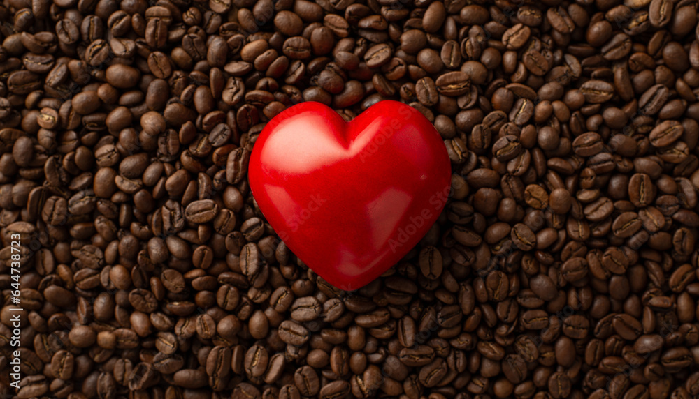 Overhead image of an array of roasted coffee beans with big red heart, signifying affection for coffee, a superb backdrop for advertising or promotion Overhead image of an array of roasted coffee beans with big red heart, signifying affection for coffee, a superb backdrop for advertising or promotion