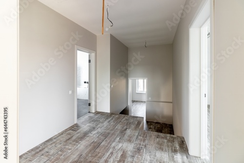 A room in a private house immediately after laying the floor  white unfinished walls and ceiling