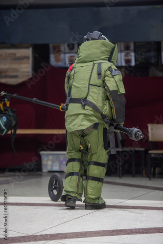 Bomb disposal officers wearing protective gear Investigating a suspected bomb in the airport building. with remote robotic arm