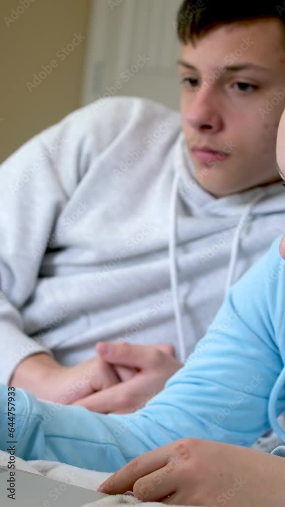 online learning teenagers boy and girl sitting near laptop and doing homework watching movie friends Classmates bedroom bed smile like each other First love online learning teenagers boy and girl sitting near laptop and doing homework watching movie friends Classmates bedroom bed smile like each other First love