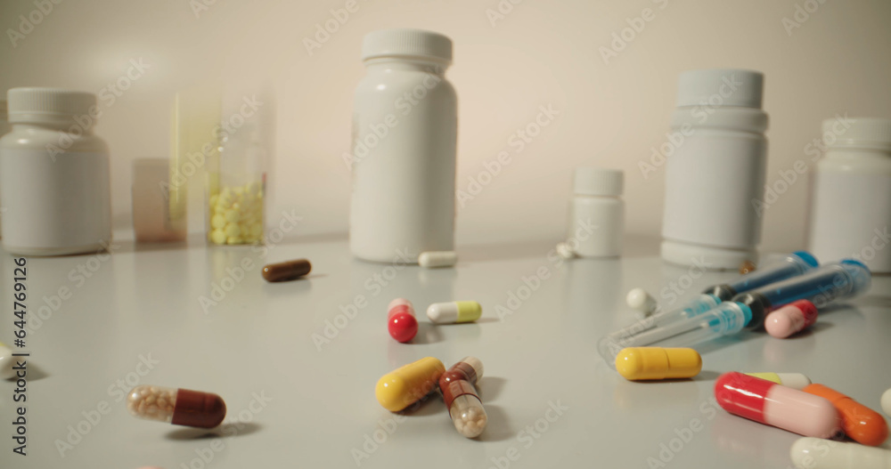 Different tablets. Copy space. The concept of medicine, disease, health. Colorful pills and tablets falling on white table with different types of drugs, pharmaceutical industry concept