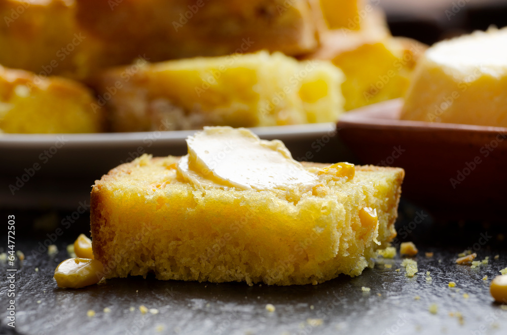 Slices of homemade cornbread and butter on kitchen table Slices of homemade cornbread and butter on kitchen table