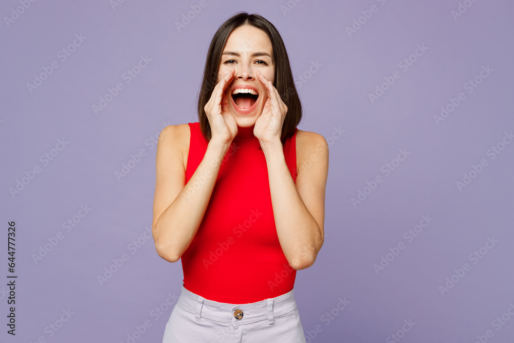 Fototapeta premium Young woman she wearing red shirt casual clothes scream loud sharing hot news about sales discount with hands near mouth isolated on plain pastel green background studio portrait. Lifestyle concept.