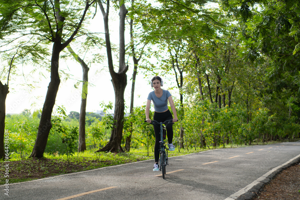 Woman riding a bicycle in the park. Healthy lifestyle and sport concept. Woman riding a bicycle in the park. Healthy lifestyle and sport concept.