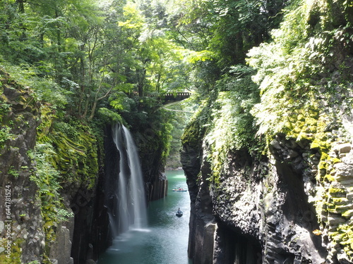 Takachiho Gorge, a narrow chasm cut through the rock by the Gokase River and partway along the gorge is the 17 meter high Manainotaki waterfall cascading down to the river below