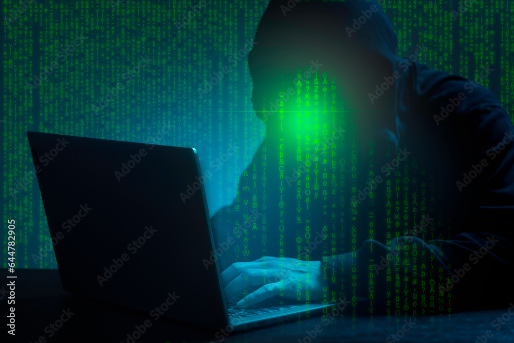 Cyber Security Concept. Computer Hacker in Hoodie. Obscured Dark Face. Hacker Attack, Virus Infected Software. Cyber Security Concept. Computer Hacker in Hoodie. Obscured Dark Face. Hacker Attack, Virus Infected Software.