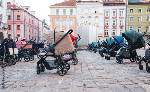Many empty prams parked on city street