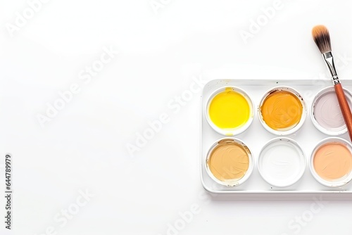 Watercolor paints and brush isolated on white background. Top view