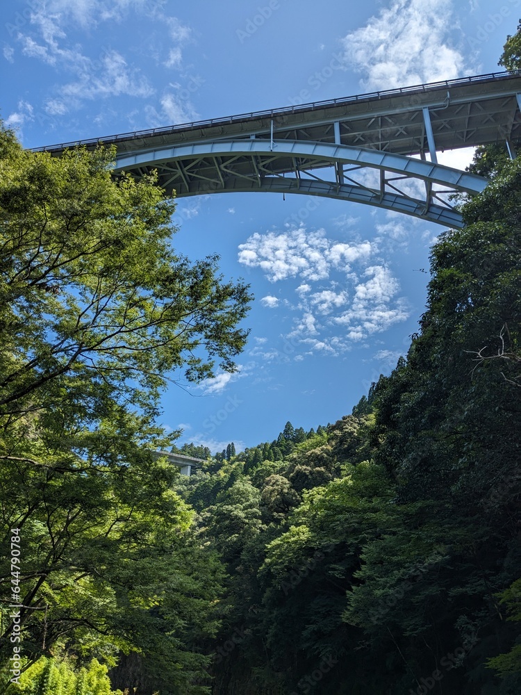 Takachiho Gorge, a narrow chasm cut through the rock by the Gokase River and partway along the gorge is the 17 meter high Manainotaki waterfall cascading down to the river below Takachiho Gorge, a narrow chasm cut through the rock by the Gokase River and partway along the gorge is the 17 meter high Manainotaki waterfall cascading down to the river below