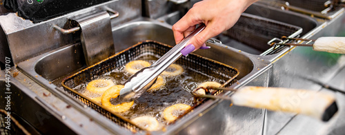 woman chef hand cooking Deep fried onion ring on kitchen