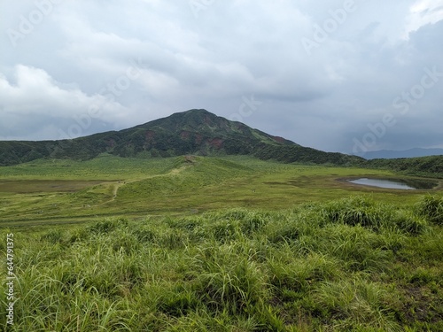 Kusasenri-ga-hama includes a rain fed pool and a 785,000-square-meter grassland growing inside an inactive crater in the foothills of Mt. Eboshi