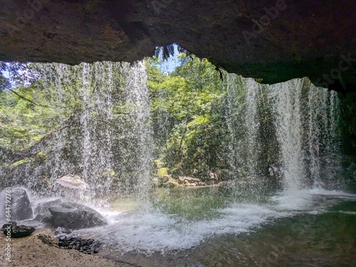 The Nabegataki Falls  where travelers can access the large cavern behind the falls