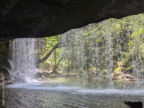The Nabegataki Falls, where travelers can access the large cavern behind the falls photo