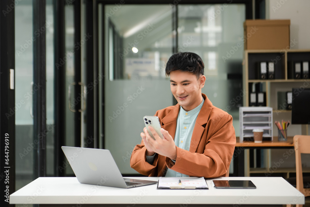 Young business man working at office with laptop, tablet and taking notes on the paper. Young business man working at office with laptop, tablet and taking notes on the paper.