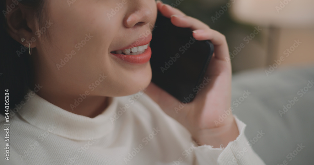 Asian woman talking with friends or family on a smartphone