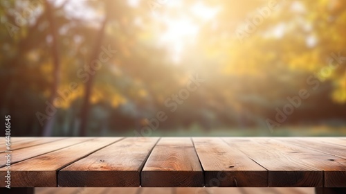 Wooden table in front of blurred autumn foliage background. Ready for product display montage 