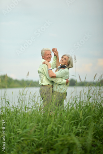 Portrait of beautiful senior couple dancing in the park © aletia2011
