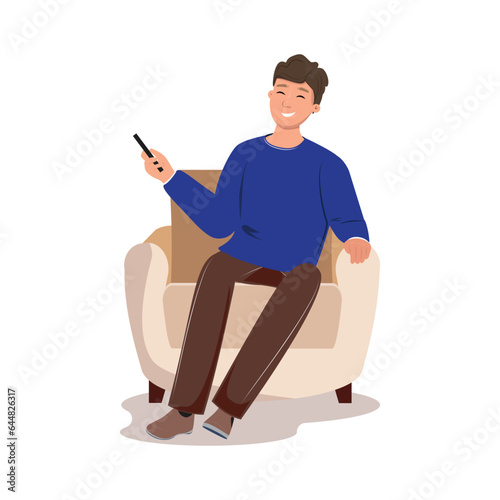 Smiling man sitting in the armchair holding a cellphone.