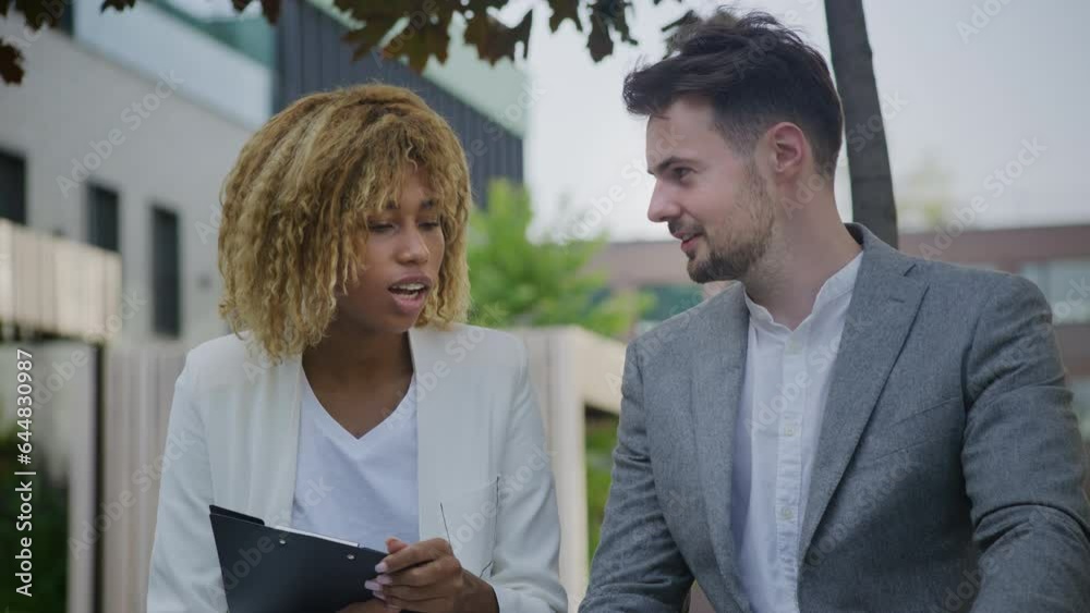 Businessman and Businesswoman Talking Outdoors Businessman and Businesswoman Talking Outdoors