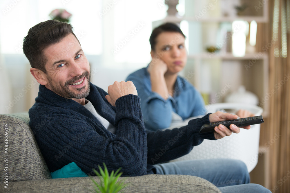 couple watching television in living room couple watching television in living room