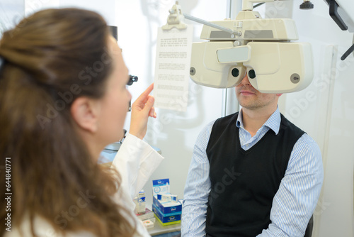 optometrist doing sight testing for patient
