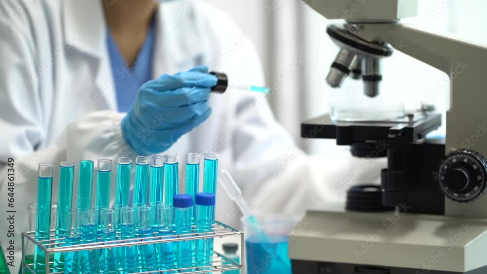 Science and medicine, scientist analyzing and dropping a sample into a glassware, experiments containing chemical liquid in laboratory on glassware, innovative and technology. Science and medicine, scientist analyzing and dropping a sample into a glassware, experiments containing chemical liquid in laboratory on glassware, innovative and technology.