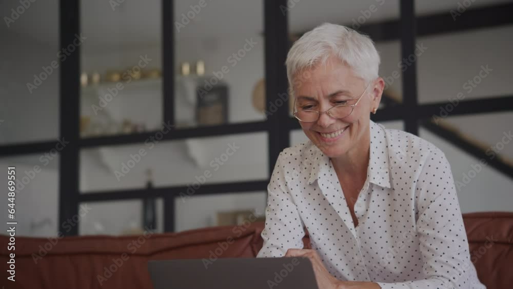 Positive Mature Woman Working on Laptop in Office Close Up Positive Mature Woman Working on Laptop in Office Close Up