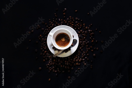 Coffee cup on black background with coffee beans photo