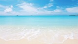Photo of a serene beach with crystal clear water and a picturesque island in the distance