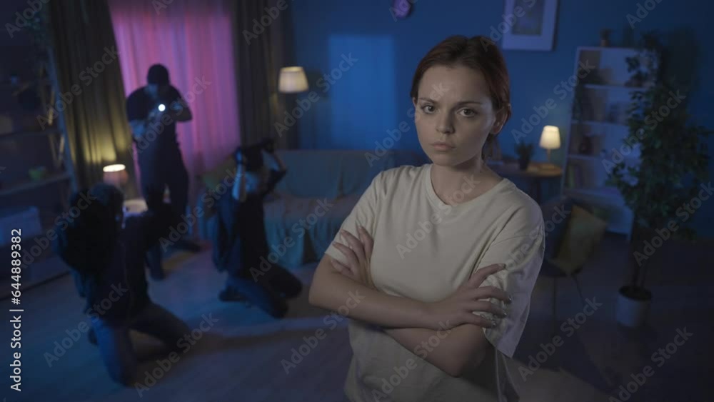 Video of two burglars, intruders, being caught red-handed in the house. Policeman is pointing a gun at them. Woman on the foreground shaking her head. Video of two burglars, intruders, being caught red-handed in the house. Policeman is pointing a gun at them. Woman on the foreground shaking her head.